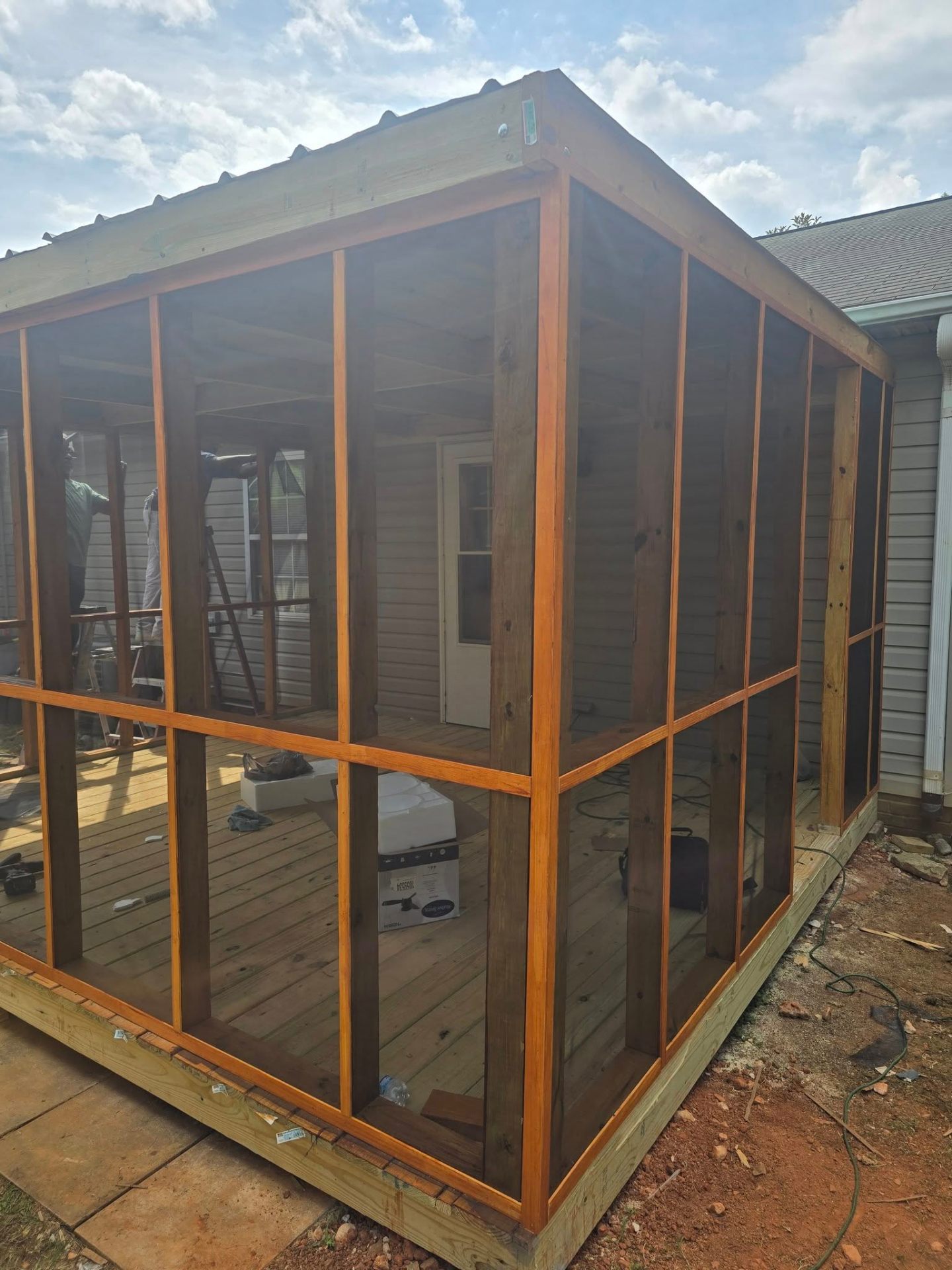 Cedar-stained screen walls installed on the porch