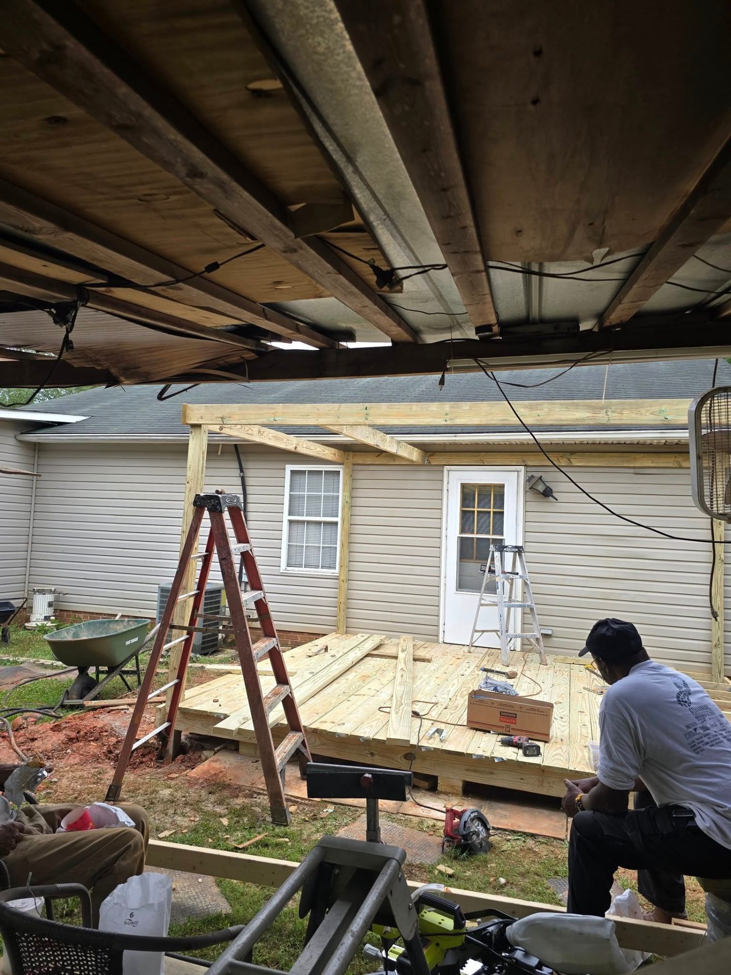 New pressure-treated deck boards being installed