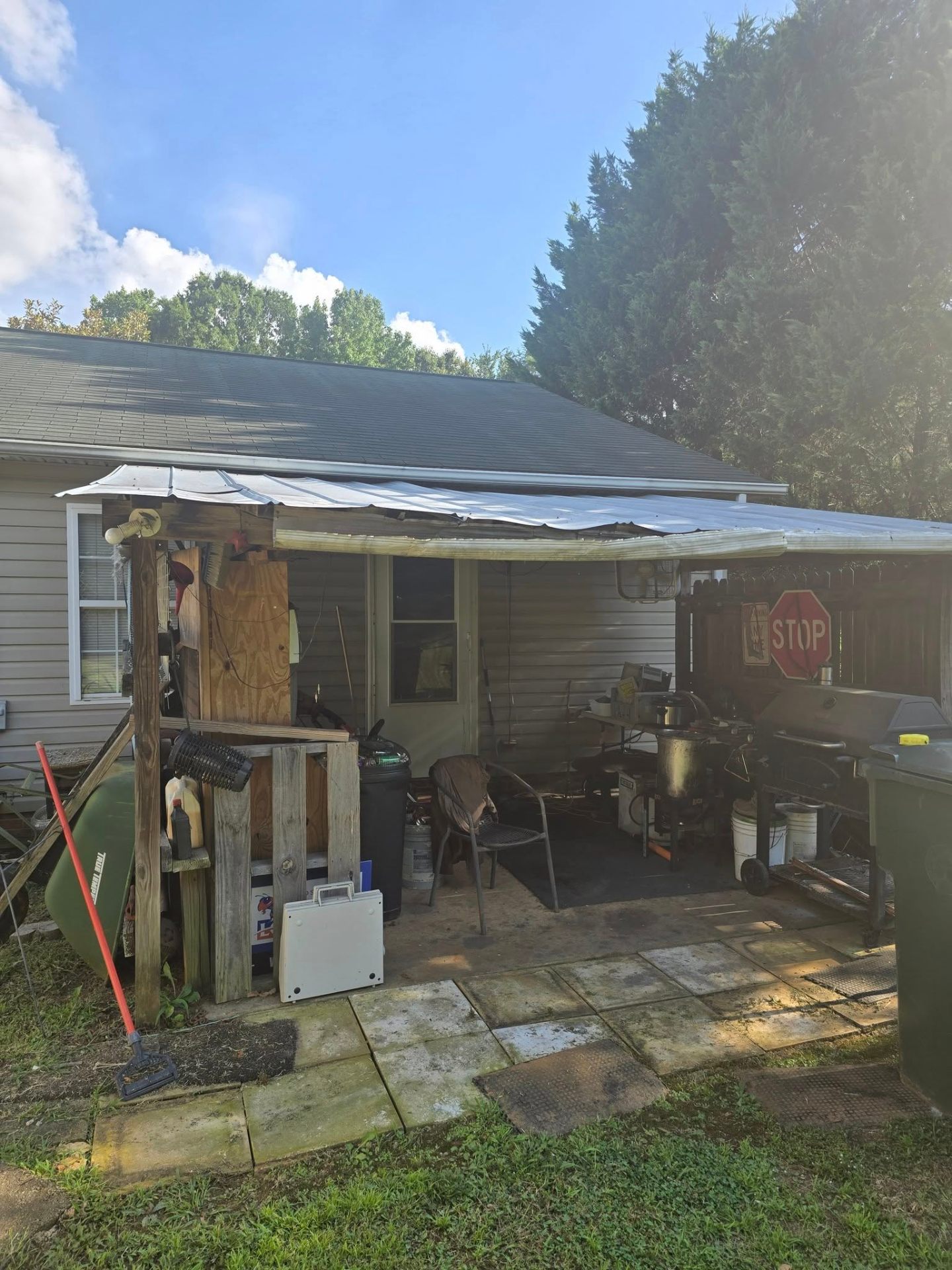 Cluttered side of the home before the porch project began